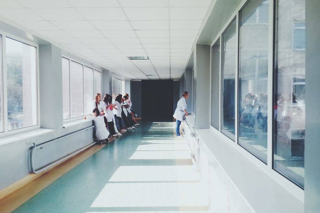 A modern hospital corridor with a reception area